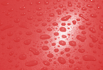 Pop art surreal style red colored water droplets on the tabletop after the rain