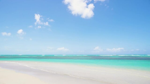 Clean and wide sea beach with white sand and transparent waves of the Indian Ocean 4k stock video footage.