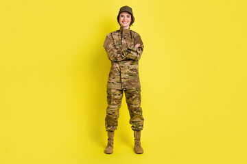 Fototapeta premium Full body photo of pretty lady standing crossed hands toothy smile isolated on yellow color background