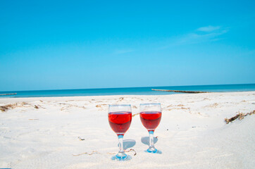 glasses of wine on the beach, picnic on the beach. Romance for a couple in love. Love with a glass of wine.