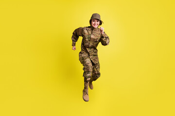 Full length photo of cheerful sportive girl rush toothy smile look camera isolated on yellow color background