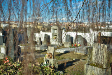 Fototapeta premium Cemetery with tombstones in the shape of a cross, angels. Many decorated graves