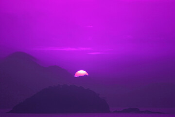 Pop art surreal style vibrant purple colored sunrise over the mountains and sea