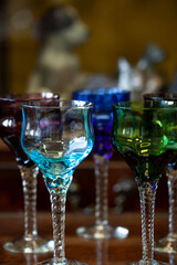 set of colored antique wine glasses with engraving. glass vintage wine glasses
