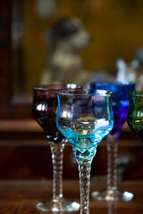 set of colored antique wine glasses with engraving. glass vintage wine glasses