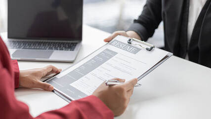 Employer or HR department is reading the resume and interviewing the ability of new employees, Employer is selecting job applicants, Employment and Recruitment Concept.