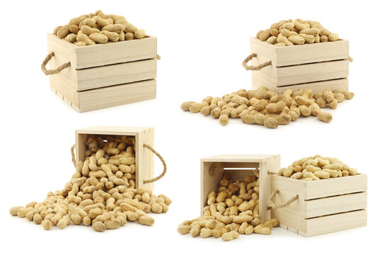 bunch of roasted peanuts in a wooden box with rope handles on a white background