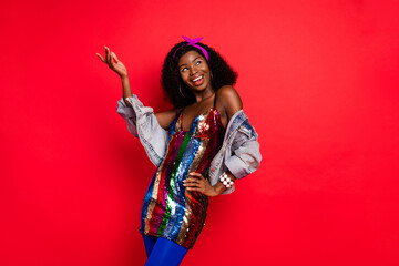 Photo of charming pretty wavy dark skin lady wear pin up outfit dancing looking empty space isolated red color background
