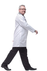 Walking mature doctor, side view. Full length studio shot