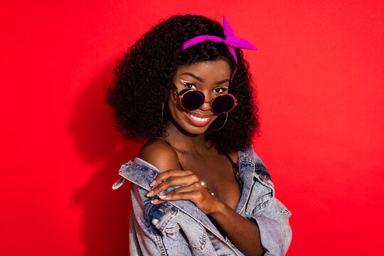 Photo of charming sweet wavy dark skin lady wear pin up outfit glasses smiling isolated red color background