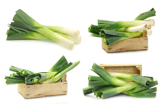 freshly  harvested leek and some in a wooden box on a white background