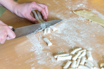 Female hands making dough for pie