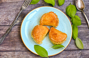 Fresh baked home made  Mini cheese puff pastries and cream  spread cheese.Cheese pie with phyllo pastry and herbs