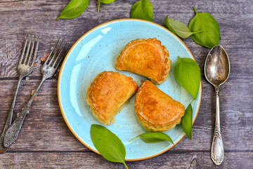 Fresh baked home made  Mini cheese puff pastries and cream  spread cheese.Cheese pie with phyllo pastry and herbs