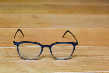 Clear eye glasses, Glasses transparent dark blue frame vintage style on wood background