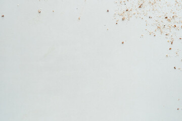 Flour texture with seeds. White surface.