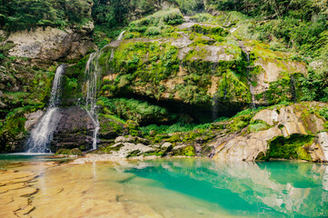 View of crystal clear water and small pond with waterfalls in the middle of the Triglav national...