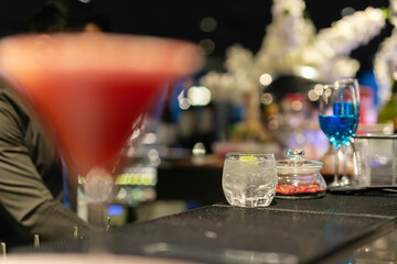 Glasses of vodka with slice of lime and ice on counter bar.