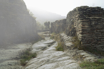 Path in fog. Misty Forest Path. Natural Stone ruin walkway through the Ruins of Schmidtburg....