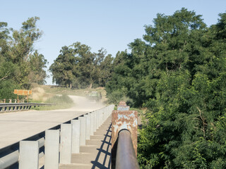 Truck and dust, over a bridge