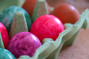 Colorful Easter Eggs in an egg carton.