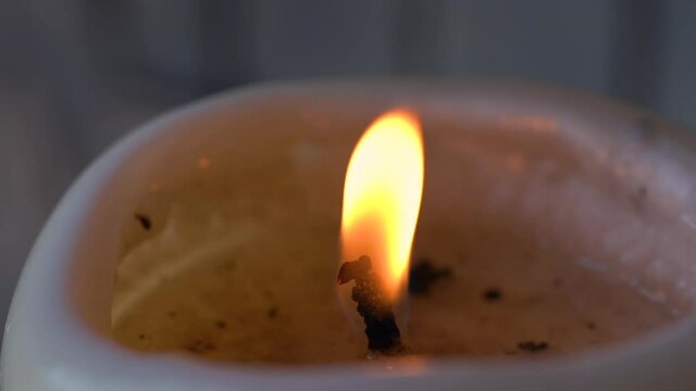 Slow motion macro footage of orange candle flame burning