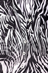 silk blouse fabric texture close-up with pockets, buttons, black and white floating line pattern