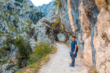 A young woman on the trail in the Picos de Europa, on the Cares route. Asturias