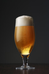 Glass of beer on dark grey background