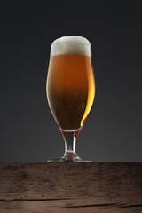 Glass of beer on dark grey background