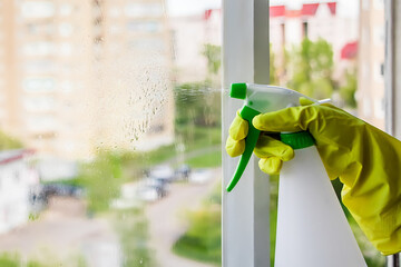 Washing windows and home cleaning. Housework concept.