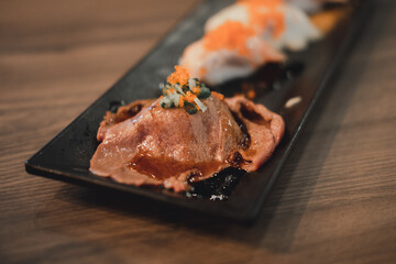 Wagyu beef sushi set with flying fish roe or Tobiko decoration on top.