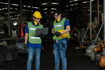 Professional Asian team engineering Man Worker at industrial factory wearing uniform and hardhats at Metal lathe industrial manufacturing factory. Engineer Operating lathe Machinery