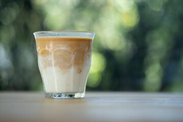 Dirty coffee iced freeze milk pour espresso shot in a cup of coffee.