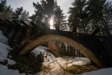 Bridge against the backdrop of the sunset in the woods