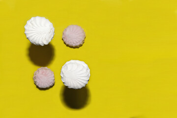 marshmallow falling on different planes against a yellow background with copy space