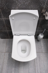 Fototapeta premium White toilet bowl and paper in a bathroom
