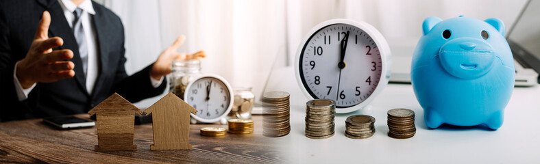 businessman holding coins putting in glass and using calculator. concept saving money and finance accounting.