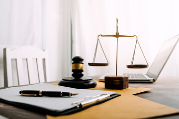 Justice and law concept.Male judge in a courtroom with the gavel, working with, computer and...