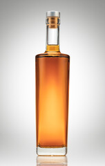 Bottle of amber color premium alcohol, isolated on white background. Ideal for mock-up of whisky,...