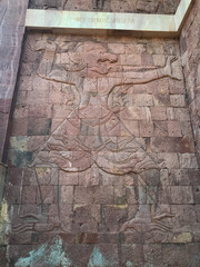 close up of ancient art buddha and animal on wall brick at Temple, Thailand