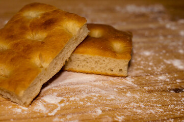 Italian Focaccia bread on a table with flour macro