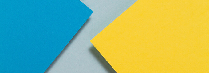 Abstract color papers geometry flat lay composition background with blue and yellow color tones