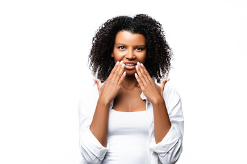 Fototapeta na wymiar Smiling african american woman with hands near face isolated on white