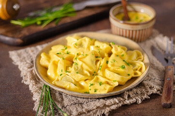 Homemade tortellini with cheese sauce