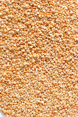 yellow peas for background. The texture of pea groats.