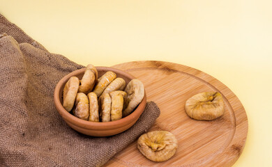 Dried fruit figs in a bowl on a background of burlap