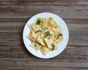 Ravioli with ricotta cheese, spinach and nuts. Healthy eating. Vegetarian food. Italian cuisine.
