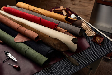 Artificial leather samples on a cow leather background. Top view.