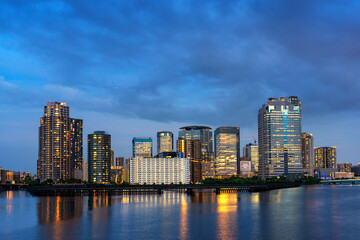 Beautiful evening scene of Sumida river with famous modern Toyosu district Tokyo, Japan, travel background